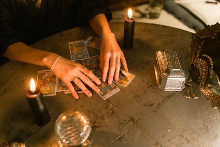 hands touching the tarot cards on the table